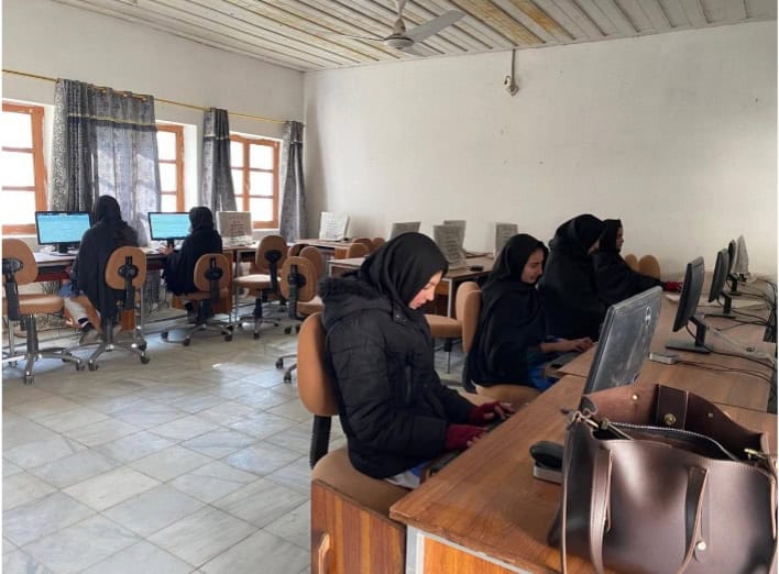 Teacher guiding students in a classroom